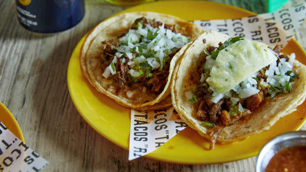 Chipotle barbacoa beef taco (left) and al pastor pork and pineapple taco.