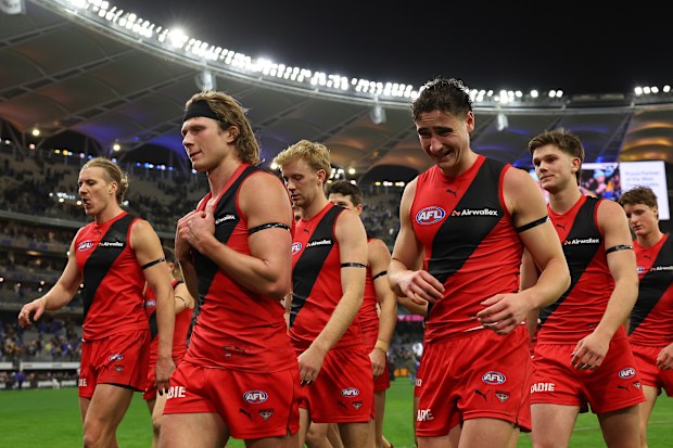 Essendon players leave the field in Perth.