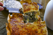 Three-cheese lasagne with overhanging edges for extra crispy bits.
