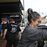 Locals start cleaning out shops and businesses along Pulteney Street in Taree.