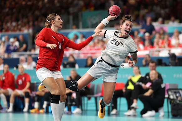 Emily Boelk of Germany shoots the ball past Line Haugsted of Denmark.