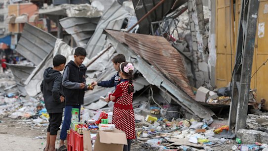 Palestinian children sell sweets outside a destroyed building in Jabaliya refugee camp in the Gaza Strip this week.