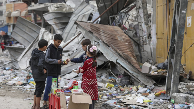 Palestinian children sell sweets outside a destroyed building in Jabaliya refugee camp in the Gaza Strip this week.