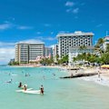 Wading out into the waters of Waikiki Beach was the only way to dispose of the lei.