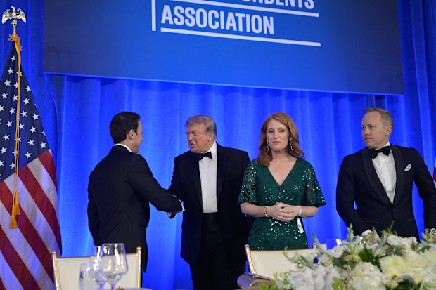 Donald Trump shakes hands at the White House Correspondents’ Association Dinner.