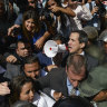 Venezuela's Guaido forces his way into parliament, takes oath in darkness