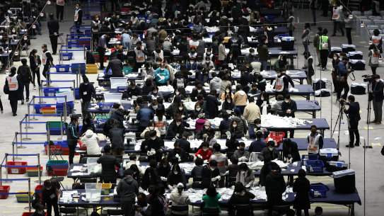 Officials in Seoul count votes cast of Parliamentary election amid the coronavirus outbreak on Wednesday April 15 in South Korea. 