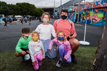 Zoe and Andrew Fleming with their children John, 11, Beatrix, 7, and Annie, 9, on day one of the Australian Open.