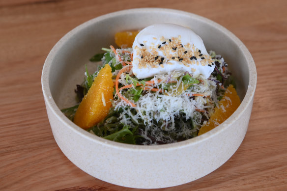 Soba salad topped with a poached egg.