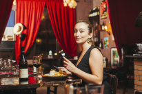 Waitress Manon Lust trying the steak frites with Marchande de vin sauce by L’Auberge du Bout du Monde restaurant in Balmain,