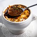 The soup's base is a reduce beef stock of depth and distinction; its cheesy topping grilled to melty magnificence.