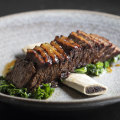 Beef short ribs with sauteed kale.