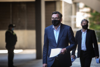 Premier Daniel Andrews and Chief Health Officer Brett Sutton arrive for Sunday's briefing.