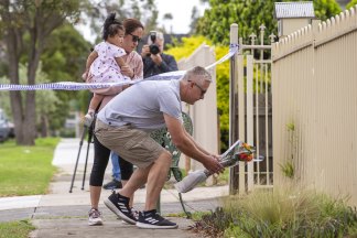 Warrick visited the scene with his wife and daughter to lay flowers on Friday morning.