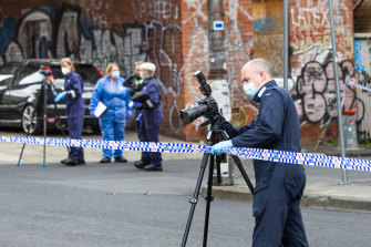 Police work a crime scene in Brunswick where two men died from stab wounds on Thursday.