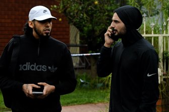 Two men who identified themselves to police as family members in Narelle crescent in Greenacre where Mahmoud Ahmad was shot dead overnight.