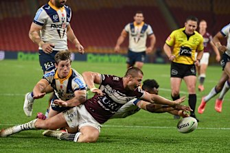 Kieran Foran battles to get to the ball first.