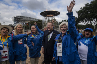 John Coates with Sydney 2000 volunteers celebrating the 20-year anniversary at the lighting of the cauldron.