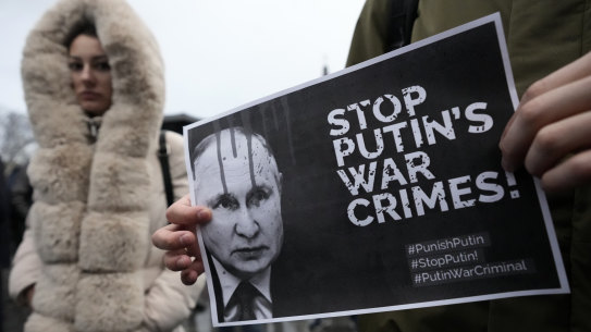 A man holds a banner showing a picture of Russian President Vladimir Putin during a protest against the Russian invasion and in solidarity with the Ukrainian people in Serbia