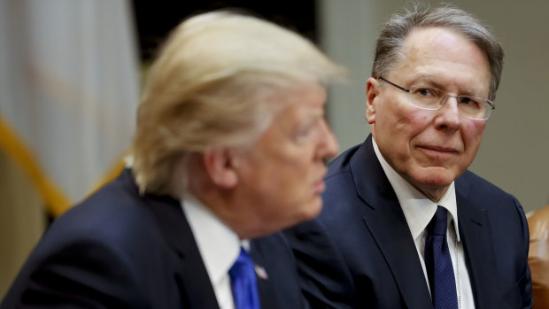 NRA head Wayne LaPierre, right, listens as President Donald Trump speaks in the Roosevelt Room of the White House.