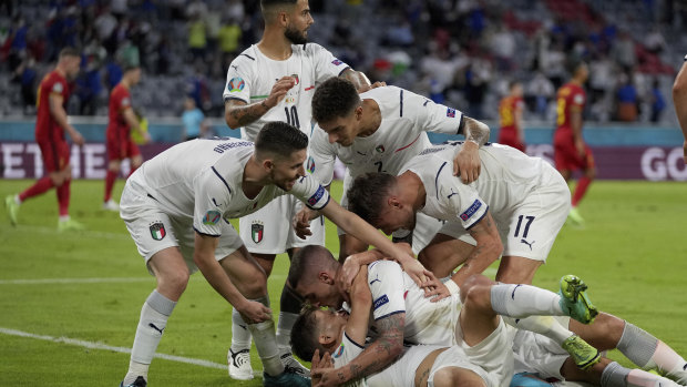 The Italians celebrate Nicolo Barella’s opening goal against Belgium.