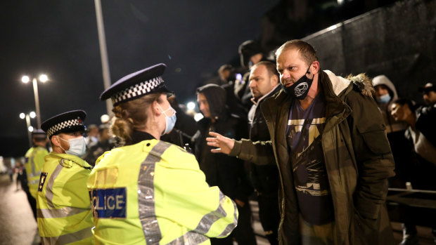 Police officers speak to a group of truck drivers at the Port of Dover.