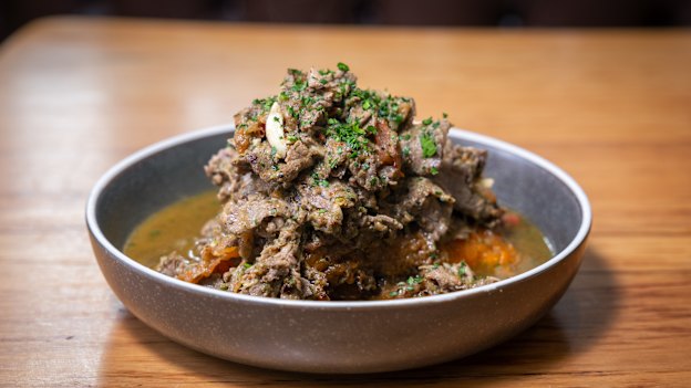 Chop Chop: thinly sliced porterhouse steak mixed with garlic and a spicy herb sauce and served on a baked sweet potato.