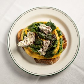 Persian eggs with dukkah, wilted spinach and sourdough.