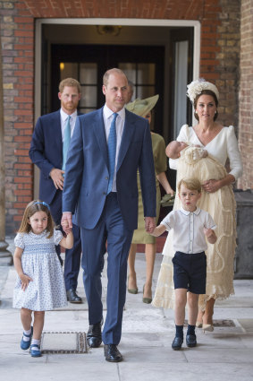 Princess Charlotte and Prince George hold the hands of their father Prince William while Kate, Duchess of Cambridge holds Prince Louis as they arrive for his christening service.