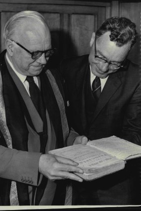The then vice-chancellor of Sydney University, professor S.H. Roberts, and R. Bolmfield, of Northbridge, examine a first edition copy, one of only four, of Sir Isaac Newton’s “Principia Mathematica” after it was given to the university in 1961.