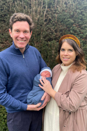 Royal flush ... Princess Eugenie sporting the ultimate accessories - a royal baby and a headband.