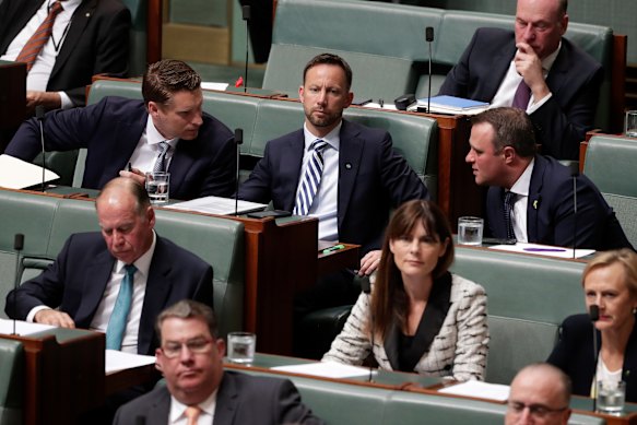 Liberal MPs Andrew Hastie (left) and Tim Wilson (right) chat in 2019 when the Coalition was in government.