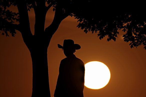A man watches the last sunset of daylight saving time, on November 6, in Kansas City, Missouri.