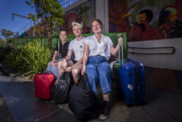 Year 12 student Lucy Skelton, (right) and friends Veronique Villis and Dan Boddington. The group is heading to Phillip Island on public transport.