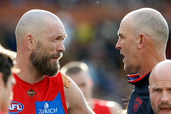 King (right) talks with Demons skipper Max Gawn.
