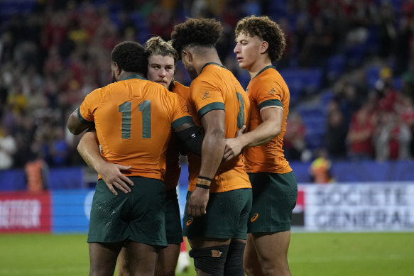 Wallabies teammates console each other after the Wales defeat.