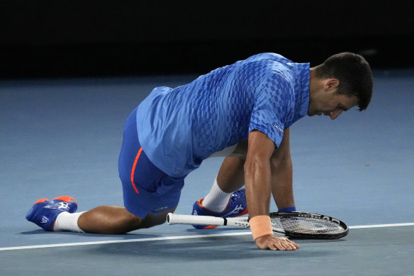 Novak Djokovic of Serbia falls to the court during his third round match against Grigor Dimitrov of Bulgaria.