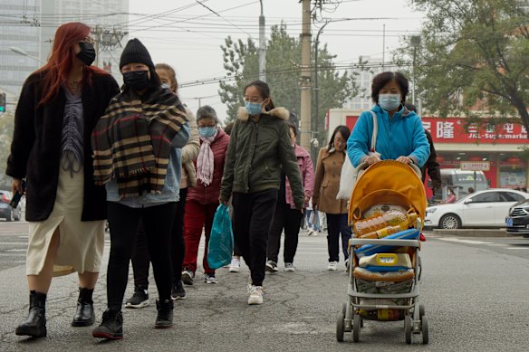 A shopper in Beijing transports cooking oil in a pram. 
