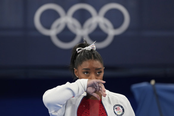 Simone Biles watches gymnasts perform at the 2020 Tokyo Olympics after she withdrew from the team finals.