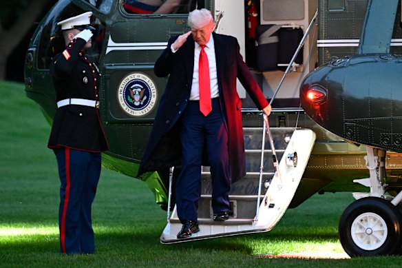 US President Donald Trump arrives on the South Lawn of the White House after attending the crypto dinner.