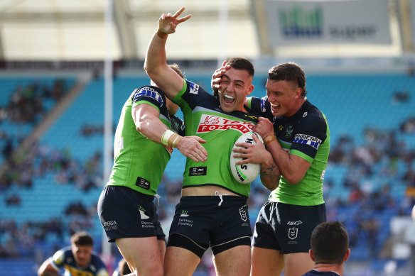 Nick Cotric celebrates a try with Raiders teammates.