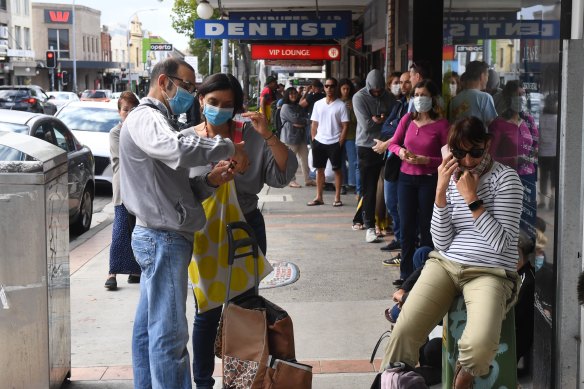 People queue down the street at Centrelink in Marrickville last year. 