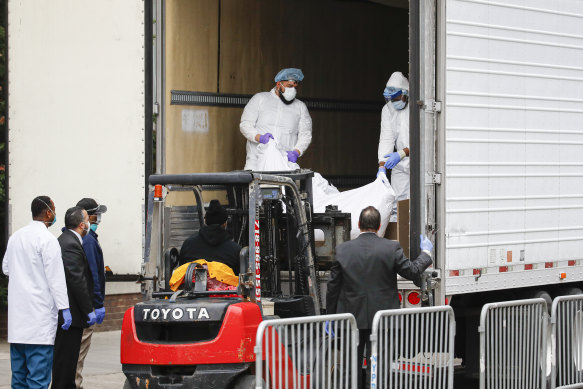 A body is loaded onto a refrigerated truck used as a temporary morgue outside Brooklyn Hospital in New York, in March.