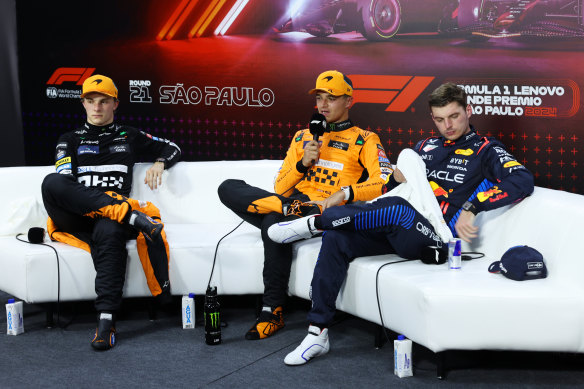 Sao Paulo GP sprint winner Lando Norris (centre) with his McLaren teammate Oscar Piastri (left), who ultimately finished second, and Max Verstappen of Oracle Red Bull (right), who finished third but was later demoted to fourth.