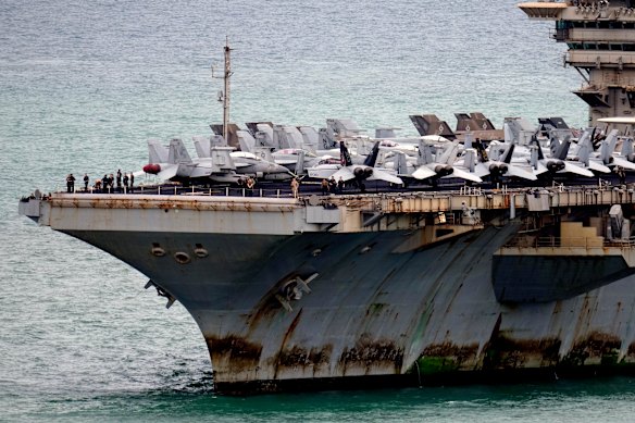 Large patches of rust and marine algae were visible on the carrier’s lower hull.