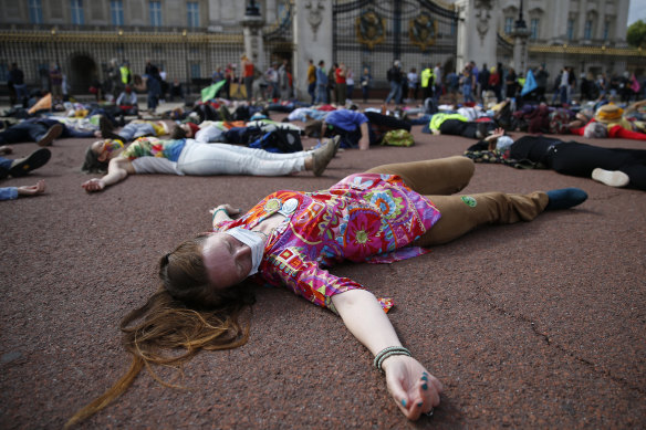 Extinction Rebellion protestors pretend to be dead outside Buckingham Palace on Saturday. The protest movement has organised a week of demonstrations across the UK. 
