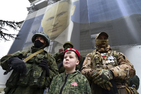 A boy and Russian soldiers mark the ninth anniversary of the Crimea annexation from Ukraine in Yalta, Crimea, last month.
