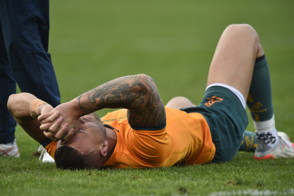 A distraught Quade Cooper lies on the turf in Mendoza.