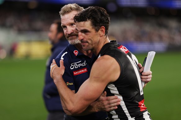 Nathan Buckley and Scott Pendlebury embrace after the game.