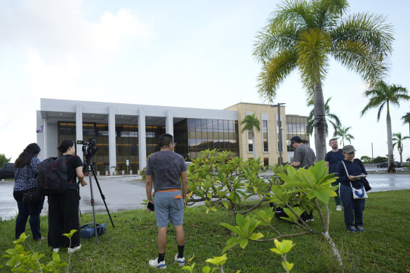 Journalists wait for WikiLeaks founder Julian Assange outside the United States courthouse where he is expected to enter a plea deal, in Saipan.